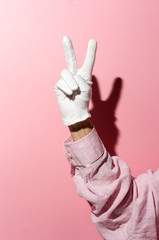 Hand with white glove with victory sign