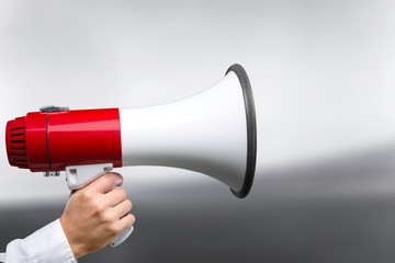 Close-up Human Hand with Megaphone on  background