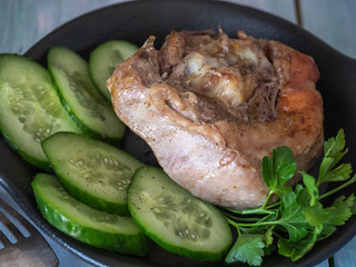 Appetizing piece of fried meat on a large clay plate. Fried potatoes with crispy crust on garnish. Tables are served for lunch and dinner at home