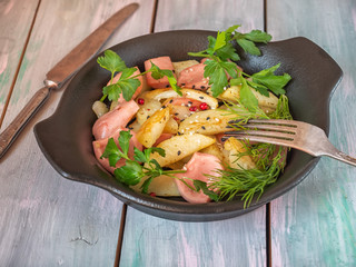 Delicious breakfast of fried potatoes and steaks of turkey and sweet potatoes, fresh parsley