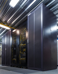 Rack server hardware in big data center with connected cables and wires