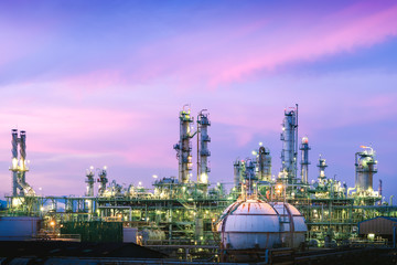 Manufacturing of petroleum industrial plant on blue sky sunset background, Glitter lighting petrochemical industry plant at twilight