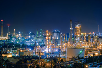 Fototapeta na wymiar Oil and Gas refinery industry plant with glitter lighting, Factory of petroleum industrial at night time, Petrochemical plant with gas distillation tower and storage tank