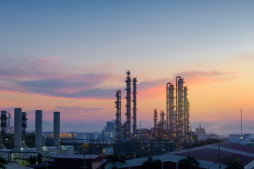 Obraz na płótnie Canvas Oil and gas refinery plant or petrochemical industry on sky sunset background, Factory at evening, Manufacturing of petroleum industrial plant