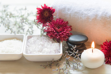 Obraz na płótnie Canvas Thai Spa Treatments aroma therapy salt and sugar scrub and rock massage with red flower with candle. Thailand. Healthy Concept