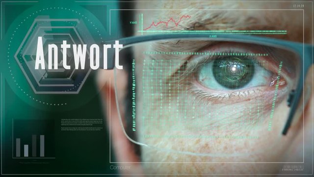 A close up of a businessman eye controlling a futuristic computer system with a Answer "Antwort" German Business concept.