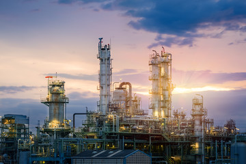 Obraz na płótnie Canvas Oil and gas refinery plant or petrochemical industry on sky sunset background, Factory at evening, Manufacturing of petroleum industrial plant