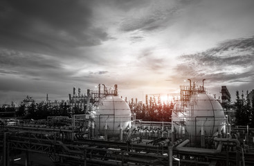 Gas storage sphere tanks and pipeline in oil and gas refinery industrial plant on sky sunset background