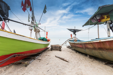 Naklejka na ściany i meble Colorful fishing boat on the sea beach at Thailand.
