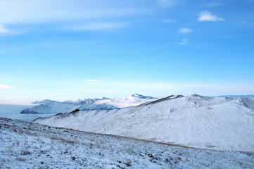 Early morning sunrise in Tazheran steppes. Snow-covered hills are colored in shades of ultra-violet. Photo toned.