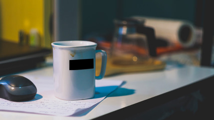 White coffee mugs with black stripes on the white desk