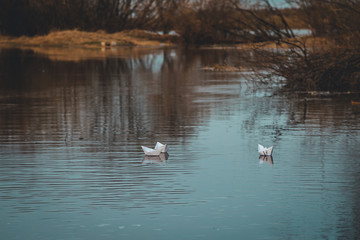 paper boats float on the river