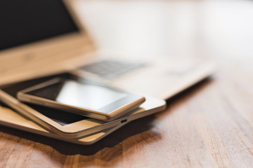 phone and tablet on a laptop