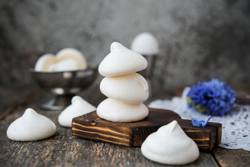 Fototapeta na wymiar Homemade white meringue of egg whites on aged wooden table