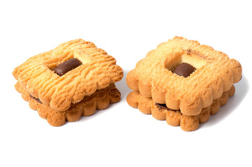 Peanut butter cookie on a white background. Golden homemade biscuit with a missing bite and trail of crumbs.