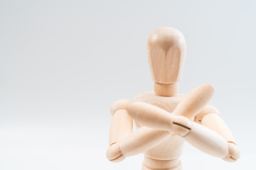 Refusal gesture, Wooden dummy, crossed hands on white background, copy space for your object or text