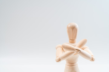 Refusal gesture, Wooden dummy, crossed hands on white background, copy space for your object or text