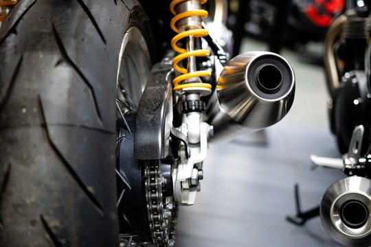 Rear view of the motorcycle. Rear wheel, exhaust pipe. Soft focus, blurred background. - Image