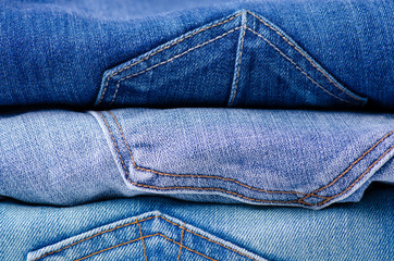 Naklejka premium Stack of jeans. Fashion jeans macro background.