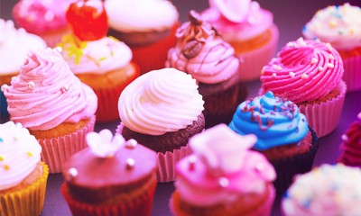 Tasty Colorful cupcakes on background