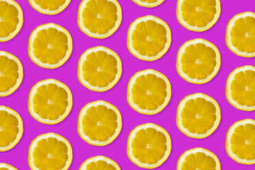 Creative pattern made of lemon. top view of fruit fresh limes slices on pink colorful background. 