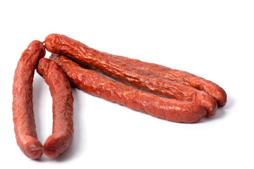 Small smoked sausages isolated on a white background.