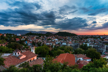 Fototapeta na wymiar sunset over Plovdiv city, Bulgaria. Panoramic view from one of the hills - Nebet tepe with walls from ancient fortress. European capital of culture 2019.