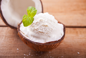 Coconut ice cream on the wooden table with mint leaf