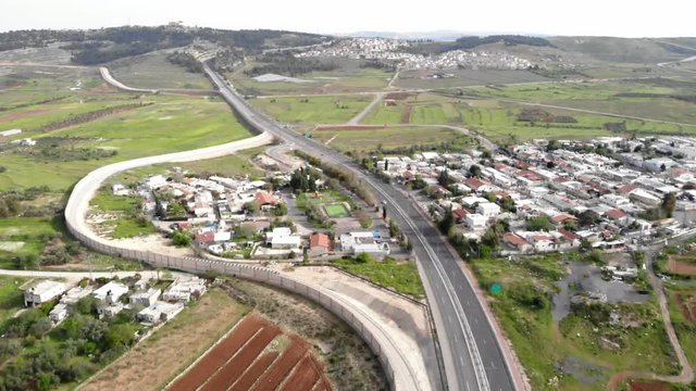 Flying over Security Wall in Israel Aerial footage of the Israeli Palestine wall close to Givon  and bir nabala town