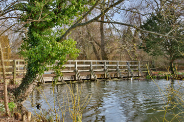 Fototapeta na wymiar Wooden footbridge over lake