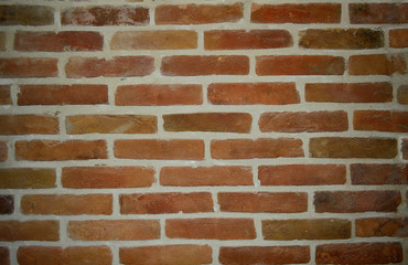 Textured wall of old brick with white seam