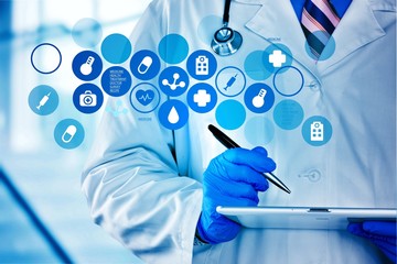Doctor with digital tablet and variety medical icons