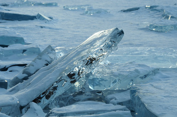 the sun's rays are refracted in crystal clear pieces of ice. winter landscape. Lake Baikal