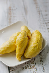 The king of fruit from Thailand, Durian in white dish with wood background.