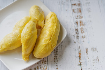 The king of fruit from Thailand, Durian in white dish with wood background.