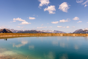 The magical panorama of the alpine lake and the Bavarian mountains, unusually clear, crystalline water reflect the colors of the sky and the forest