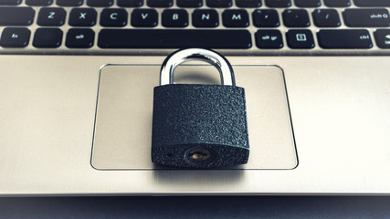 Laptop Keyboard With Locker concept photo protected locked virus  password protection hacker attack