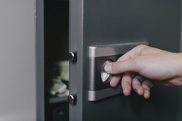 Naklejka premium man opens safe, combination lock