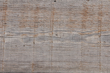 Texture photo of grey, worn, shabby, old and cracked wood which was exposed to weather and sun for years. Ideal as a background