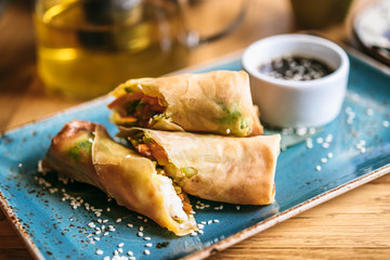 The plate of spring rolls with sweet teriyaki sauce