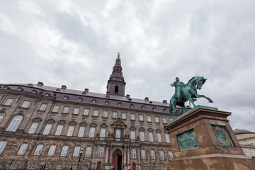 Fototapeta na wymiar Looking up at the Christiansborg Palace and Frederik VII statue in Copenhagen, Denmark.