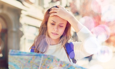 Lost tourist looking at city map on a trip. Looking for directions.