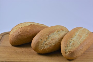 assortment of fresh wheat bread in the bakery on white background