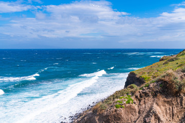 Santorini landscape - view of rugged cliffs and Aegean Sea, Greece