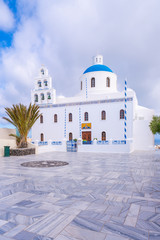 Beautiful white Church of Panagia with blue dome in the main square of Oia, Santorini, Greece