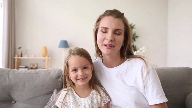 Happy Mother And Child Making Video Call Looking At Camera