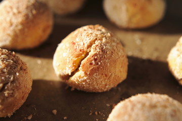 Close-up of a baked bun with side solar lighting. Fresh cottage cheese bread for healthy eating at home recipe