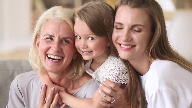 Three generations women happy family having fun embracing cuddling