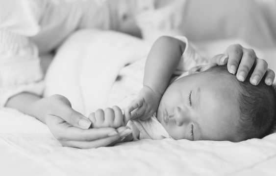 Newborn baby holding mother's hand with love.New family and baby healthy concept. image with depth of field