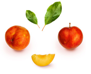 Yellow and orange plums (variety known as honey or mirabelle) isolated on white background. They include whole plums, segments and leaves. Color yellow, orange, orange. 